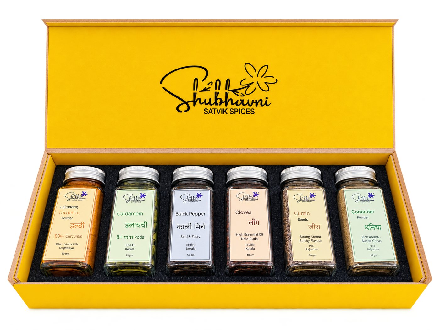 Shubhavni Satvik Spices box open, with six glass jars of Lakadong haldi, elaichi, kali mirch, laung, jeera and dhaniya