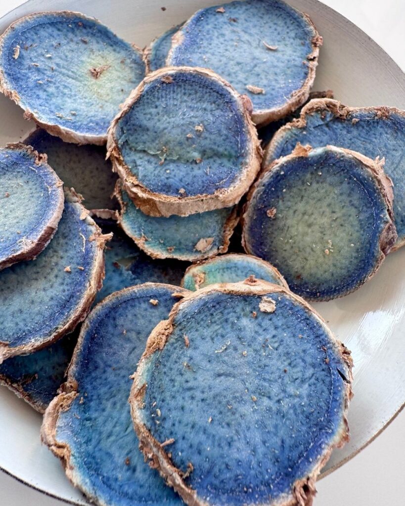 Slices of Shubhavni kali haldi rhizome, blue inside with a brown skin